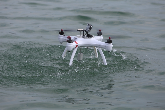 드론이 울주군 서생면 신암항 앞바다에서 적조 밀도를 분석하기 위한 바닷물을 채수하고 있다. 울산시 제공