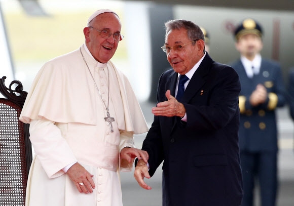 프란치스코(왼쪽) 교황이 쿠바 아바나에 도착한 19일(현지시간) 라울 카스트로 국가평의회 의장이 공항에 나가 교황을 영접하고 있다. 프란치스코 교황이 ‘포프모빌’(교황의 차량)을 타고 퍼레이드를 벌이는 동안 거리에는 10만명이 넘는 시민들이 나와 열광했다. 아바나 AFP 연합뉴스
