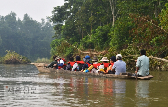 여행객들이 치트완 전통 카누 ‘둥가’를 타고‘침묵의강’ 랍티강을 따라 깊숙한 밀림으로 들어가고 있다.