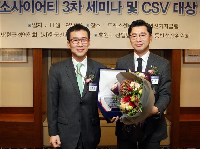 지난 19일 서울 중구 세종대로 한국프레스센터에서 열린 한국경영학회 공유가치창출(CSV)대상 시상식에서 산업발전부문 대상을 받은 CJ대한통운의 신동휘(오른쪽) 부사장이 문동민 산업통상자원부 과장과 기념사진을 찍고 있다.  CJ대한통운 제공