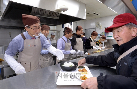 김영종(왼쪽) 종로구청장이 30일 종로노인종합복지관에서 송년회 대신 배식 봉사를 하고 있다.  최해국 선임기자 seaworld@seoul.co.kr 