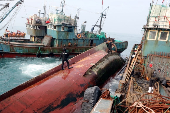 27일 오전 전남 신안군 흑산면 가거도 북서쪽 85km 해상에서 중국어선이 전복돼 해양경찰이 구조 작업을 벌이고 있다.  국민안전처 제공