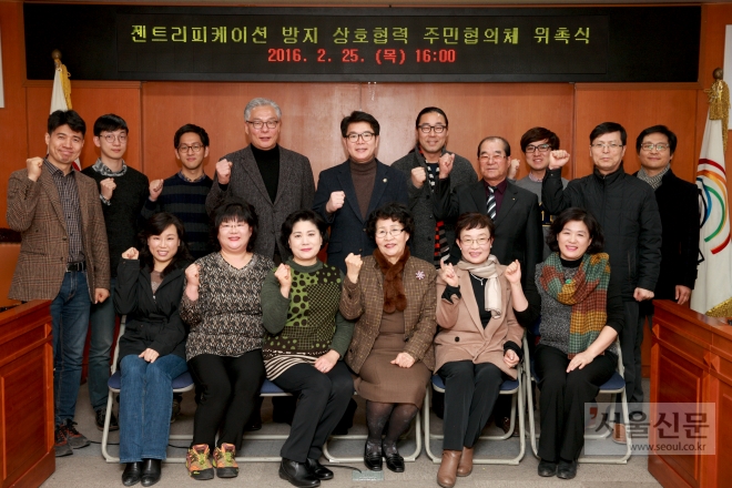 지난 25일 서울 성동구청에서 열린 ‘젠트리피케이션 방지를 위한 주민협의체 위촉식’ 후 정원오(뒷줄 가운데) 성동구청장이 파이팅을 하고 있다. 성동구 제공 