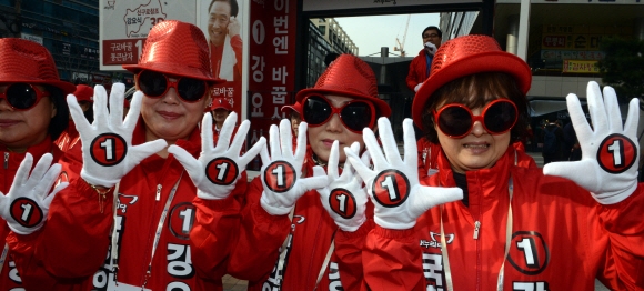 새누리당 선거운동원들이 31일 서울 구로구 이마트 앞에서 ‘기호 1번’이 새겨진 장갑을 펴보이며 지지를 호소하고 있다.  이종원 선임기자 jongwon@seoul.co.kr