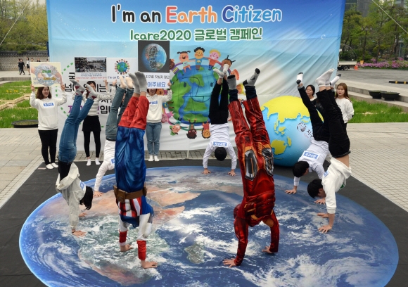 46번째 지구의날인 22일 종로구 세종대로 시민열린마당에서 지구시민운동연합 회원들과 벤자민인성영재학교 학생들이’I’m an Earth Citizen’슬로건을 걸고 지구를 중심가치로 생각하고 행동하는 1억 명을 만들자는 ’ICARE 2020 캠페인’을 벌이며 지구를 밝지 않고 들어올린다는 의미로 물구나무를 서는 퍼포먼스를 하고 있다.    2016.04.22 강성남 선임기자 snk@seoul.co.kr
