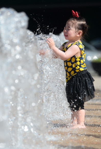 서울 낮 기온이 31도까지 올라가면서 여름날씨를 보인 18일 서울광장 분수대에서 어린이들이 물놀이를 하고 있다.  정연호 기자 tpgod@seoul.co.kr