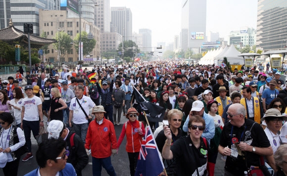 미세먼지 농도가 다소 옅어진 28일 오전 서울 세종로에서 열린 ‘2016 국제로타리 세계대화 3K 평화의 걷기’에서 참가자들이 각국 전통 의상을 입고 광화문네거리를 걷고 있다. 사진=연합뉴스