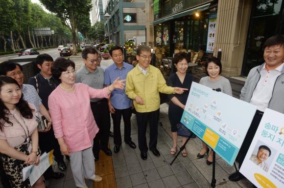 박춘희(앞 왼쪽 두 번째 분홍 재킷) 송파구청장이 27일 서울 잠실동 석촌호수 카페거리에서 상인, 주민들과 함께 젠트리피케이션 방지를 위한 토론을 하고 있다.송파구 제공