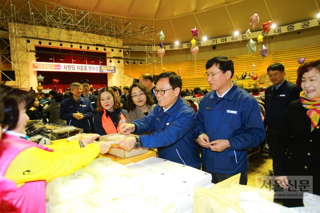 강환구(왼쪽) 현대중공업 사장과 한영성 현대미포조선 사장이 2일 울산 본사 사내 체육관에서 열린 ‘사랑의 기증품 판매전’을 둘러보며 관계자들을 격려하고 있다. 현대중공업 제공 