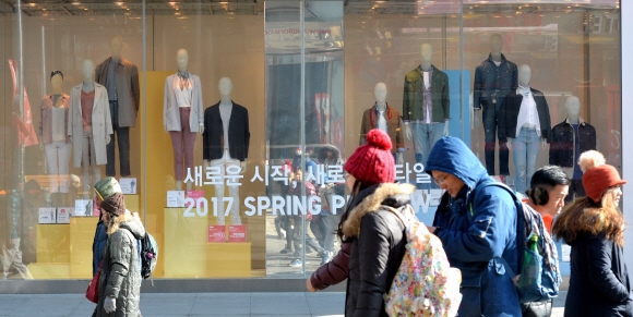 입춘을 사흘 앞둔 1일 봄옷이 내걸린 서울 중구 명동의 한 의류매장 앞을 두꺼운 패딩 차림을 한 시민들이 지나가고 있다. 손형준 기자 boltagoo@seoul.co.kr