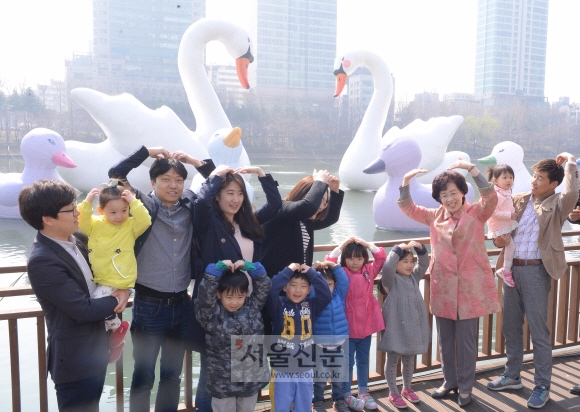 박춘희(오른쪽 세 번째) 송파구청장이 3일 석촌호수에 띄워진 스위트 스완을 어린이, 시민들과 함께 감상하며 머리에 하트 모양을 그리고 있다. 최해국 선임기자 seaworld@seoul.co.kr