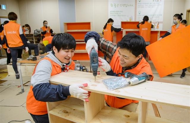 지난해 말 사내 사회공헌 캠페인인 ‘오렌지 희망 하우스’에 참가한 ING생명 직원들이 서울의 한 어린이 공부방을 고쳐 주고 있다. ING생명 제공