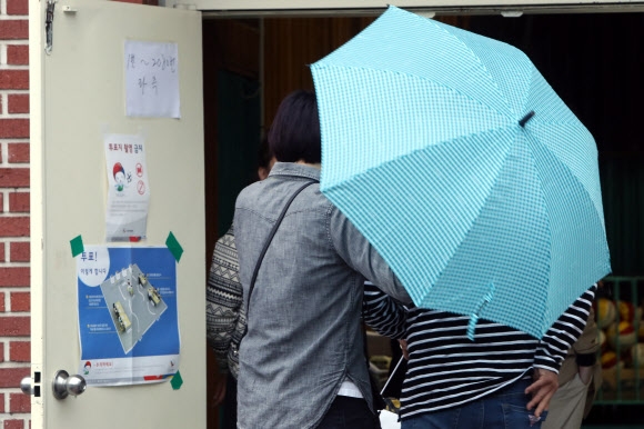 ‘비가 내려도 투표 참여’