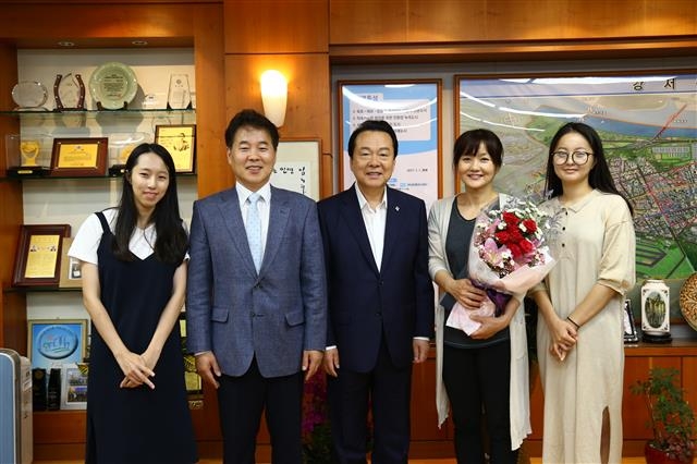 노현송(가운데) 강서구청장이 22일 60만번째 구민이 된 강현주(오른쪽 두 번째)씨와 가족들을 청장실로 초청해 ‘60만 주민 인증서’를 전달한 뒤 기념사진을 찍고 있다. 강서구 제공