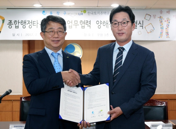 5일 서울 동작구청에서 박상우(왼쪽) 한국토지주택공사(LH) 사장과 이창우 동작구청장이 종합행정타운 건립 사업 양해각서(MOU)를 체결한 뒤 악수하고 있다. 연합뉴스