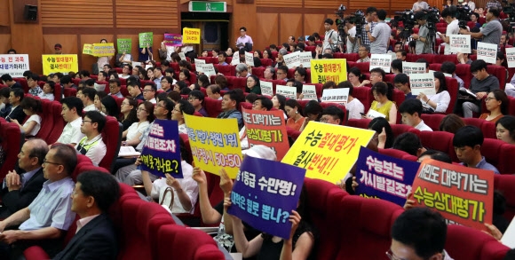 지난 11일 서울 서초구 서울교대에서 열린 2021학년도 수능 개편안 공청회에서 수능 전 과목 절대평가 도입을 반대하는 시민단체들이 반대 피켓을 든 채 공청회를 듣고 있다. 교육부는 지난 10일 수능 일부 과목만 절대평가를 도입하는 안과 전 과목을 절대평가하는 안을 제시했지만, 학교생활기록부의 신뢰를 회복하지 못하는 이상 수능 절대평가의 부작용이 심화될 것이라는 우려가 나오면서 최근 학교생활기록부의 개선 작업에 착수했다. 연합뉴스