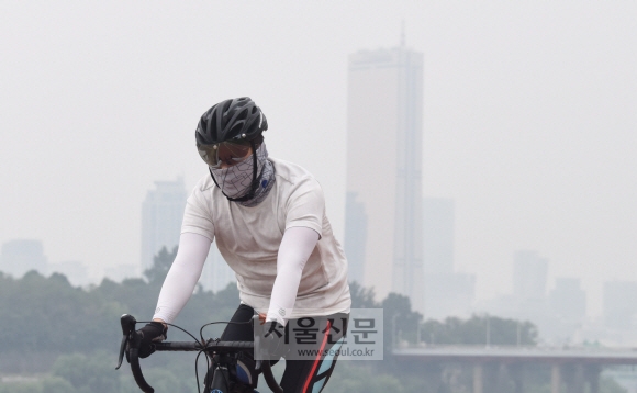 미세먼지가 나쁜수준을 보이고 있는 가운데  10일 서울 여의도한강공원에서 시민이 마스크를 쓴 채 자전거를 타고 있다. 2017.9.10  최해국 선임기자 seaworld@seoul.co.kr