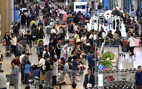 역대 최대의 공항 도착객이 몰린 8일 인천국제공항에서 도착승객들이 입국장을 가득 채우고 있다. 2017.10.8  박지환 기자 popocar@seoul.co.kr