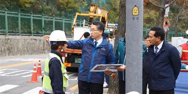 김영종(가운데) 종로구청장이 지난해 서촌의 명소로 조성한 윤동주문학관 인근에서 통행을 방해하는 전봇대 등 각종 시설물을 통합하는 사업을 지시하고 있다.  종로구 제공 김영종(가운데) 종로구청장이 지난해 서촌의 명소로 조성한 윤동주문학관 인근에서 통행을 방해하는 전봇대 등 각종 시설물을 통합하는 사업을 지시하고 있다.  종로구 제공