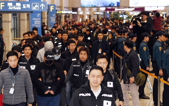 국내에서 범죄를 저지르고 필리핀으로 도피했다 붙잡혀 송환된 피의자 47명이 호송관들과 함께 국적항공 전세기편으로 14일 인천국제공항에 들어오고 있다. 박윤슬 기자 seul@seoul.co.kr