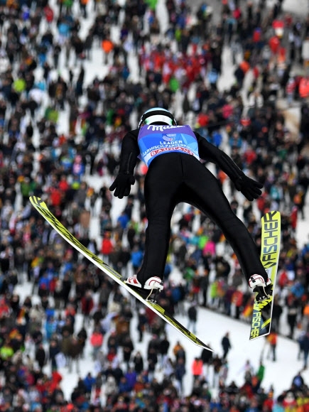 폴란드의 카밀 스토흐가 1일(현지시간) 독일 가르미슈파르텐키르헨에서 열린 2017~18시즌 국제스키연맹(FIS) 월드컵 스키점프 남자 라지힐 종목 연습 점프 도중 팔을 뒤로 쭉 뻗으며 하늘로 솟구치고 있다.  가르미슈파르텐키르헨 AFP 연합뉴스