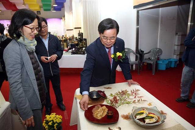노 군수가 2016년 10월 한산소곡주 축제장을 찾아 전시물품을 살펴보고 있다. 서천군 제공