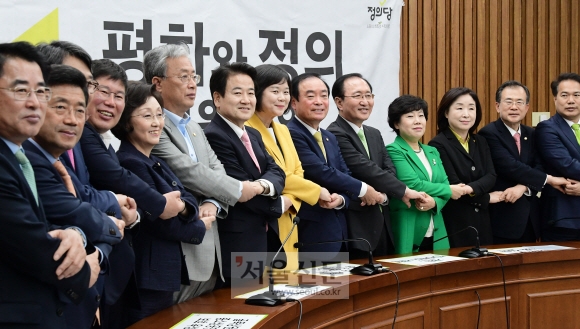 공동 원내교섭단체인 평화와 정의를 구성한 민주평화당 조배숙 대표, 정의당 이정미 대표 등 양당 의원들이 2일 국회에서 열린 상견례 겸 의원총회에서 손을 맞잡고 기념사진을 촬영하고 있다. 이종원 선임기자 jongwon@seoul.co.kr