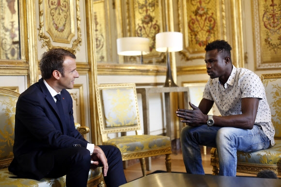 에마뉘엘 마크롱(왼쪽) 프랑스 대통령이 28일 엘리제궁으로 가사마(오른쪽)를 초청해 감사장을 전달한 뒤 이야기를 듣고 있다. 파리 AP 연합뉴스