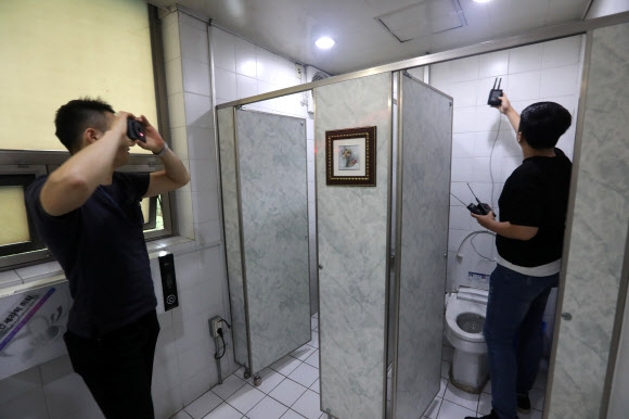 여자 화장실에서 보안업체 직원들이 몰래카메라 설치 여부를 점검하는 모습. 연합뉴스
