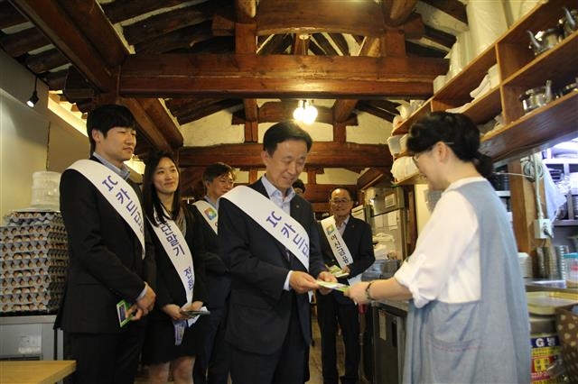 김덕수(가운데) 여신금융협회장이 11일 서울 종로구 한 음식점에서 가맹점주에게 IC 카드 단말기 전환의 필요성을 설명하고 있다. 여신금융협회 제공