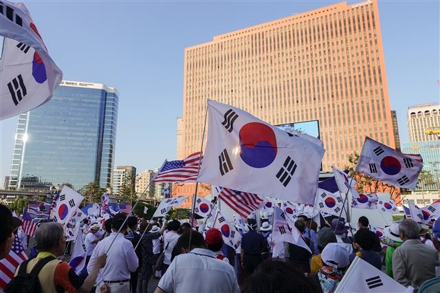 친미·반북 집회 열성 참가자들인 이른바 ‘태극기 부대’가 제7회 전국동시지방선거를 하루 앞둔 지난 12일 서울역 앞에서 열린 대한애국당 지지 집회에 참석해 태극기와 성조기를 흔들고 있다. 류재민 기자 phoem@seoul.co.kr