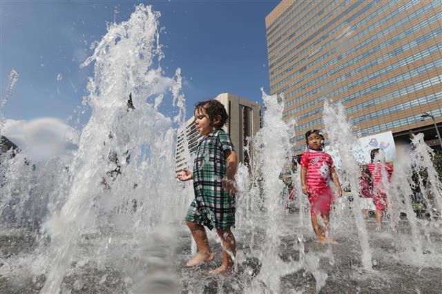 폭염이 이어지는 4일 오후 서울 광화문광장 분수대를 찾은 아이들이 물놀이를 하고 있다. 2018.8.4 뉴스1
