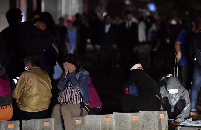 일본 북단 홋카이도 남쪽에서 6일 새벽 3시 8분께 규모 6.7의 지진이 발생했다. 사진은 이날 지진으로 정전이 발생한 삿포로 시내에서 시민들이 피곤한 모습으로 길가에 앉아 있는 모습. 2018.9.6 연합뉴스