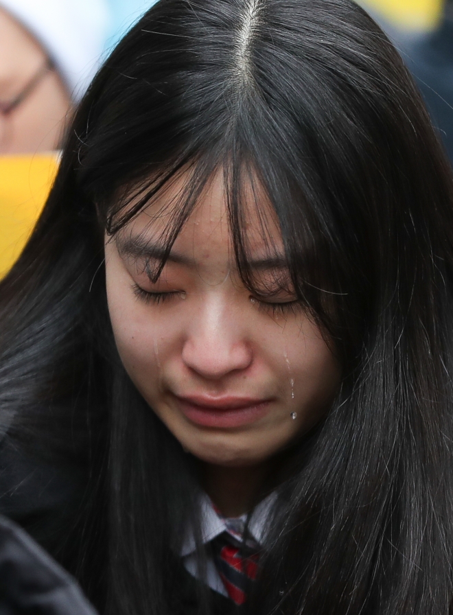 정부가 지난 2015년 한일 합의로 만들어진 화해 치유재단의 해산을 추진한다고 공식 발표한 21일 서울 종로구 옛 일본대사관 앞에서 열린 제1362차 일본군 성노예제 문제 해결을 위한 정기 수요시위에서 한 학생이 위안부 피해 할머니의 음성을 들으며 눈물을 흘리고 있다. 2018.11.21 뉴스1