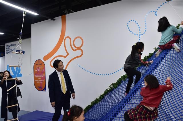 문석진 서울 서대문구청장이 13일 서대문문화체육회관에 문을 연 서대문키즈헬스케어센터 ‘아이랑’에서 그물 놀이터 놀이를 즐기는 어린이들을 바라보며 활짝 웃고 있다.  서대문구 제공