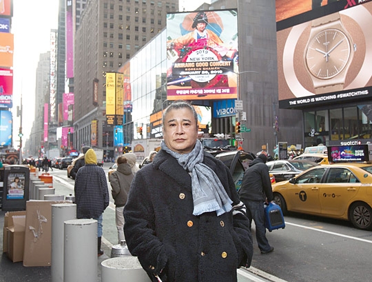 무당금파가 자신의 공연을 소개하는 타임스퀘어 동영상 광고 전광판 앞에서 포즈를 취하고 있다. 오른쪽 작은 사진은 카네기홀 홈페이지에 소개된 ‘아리랑 굿 콘서트’.