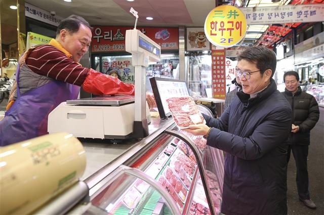정원오(오른쪽) 성동구청장이 지난 22일 민생투어 첫 일정으로 찾은 마장축산물시장에서 한 점포에 들러 소고기를 사고 있다. 성동구 제공