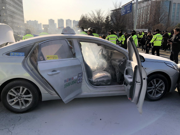 11일 오후 서울 여의도 국회 앞 도로에서 한 택시기사가 분신을 시도했다. 경찰 및 소방 관계자들이 현장을 정리하고 있다. 2019.2.11 <br>연합뉴스
