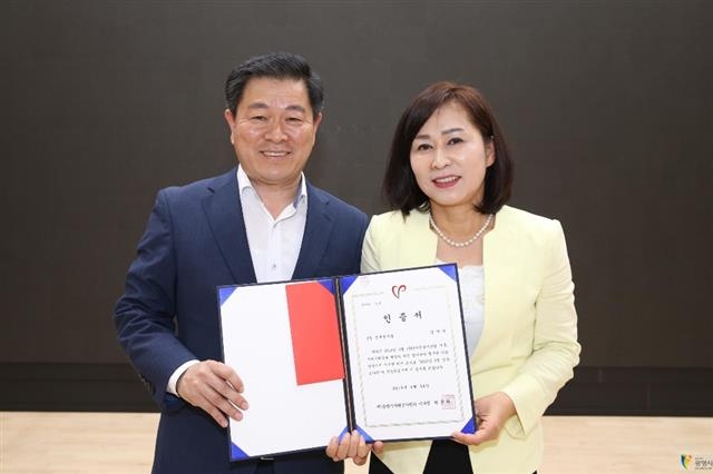지난 3월 ‘이달의 신규 봉사왕’에 뽑힌 김미숙(오른쪽)씨가 박승원 광명시장과 기념사진을 찍고 있다.  광명시 제공