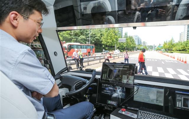 5G 자율주행 버스 도심 주행 22일 서울 마포구 상암동 디지털미디어시티(DMC)에서 열린 ‘상암 자율주행 페스티벌’에서 5G(5세대) 기반 신호 인식 등이 적용된 자율주행 버스가 보행자가 길을 건너기를 기다리고 있다.  뉴스1