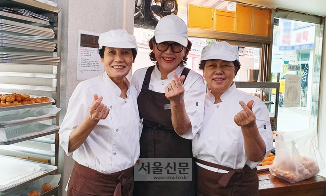 서울 은평구 녹번동 꽈배기 나라 1호점에서 일하는 오영옥(65)씨(왼쪽부터), 안국희(75)씨, 최선화(66)씨가 지난달 26일 카메라를 향해 손하트를 만들어 보이고 있다.