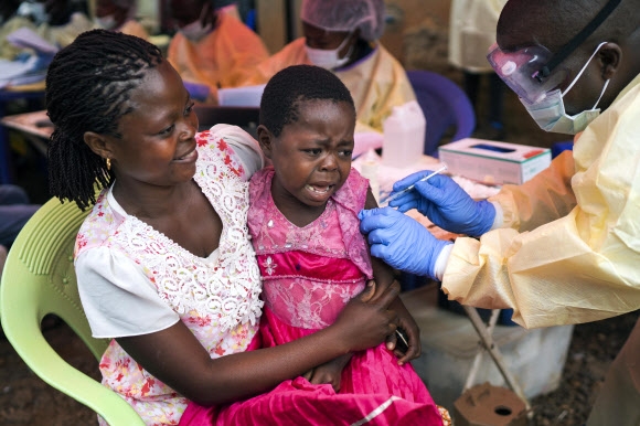 콩고민주공화국 베니에 사는 한 소녀가 지난 13일(현시간) 엄마 품에 안겨  에볼라 바이러스의 백신 접종을 맞고 있다. 베니AP 연합뉴스