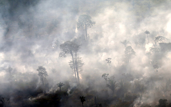 An aerial view of a burning tract of Amazon jungle as it is cleared by loggers and farmers near Porto Velho