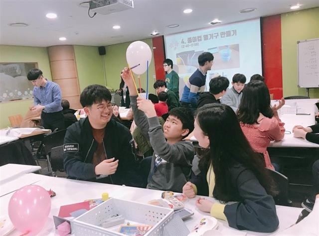 지난 3월 서울 관악구 자원봉사센터에서 열린 ‘골뱅이 어울림학교’에서 대학생 멘토가 아이들과 어울리며 놀이 수업을 하고 있다. 관악구 제공