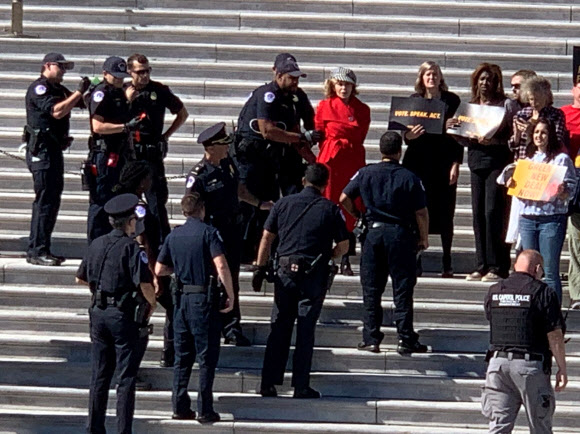11일(현지시간) 할리우드의 원로 영화배우 제인 폰다가 미국 워싱턴DC 국회의사당 앞에서 열린 기후변화 시위 도중 경찰에 체포되고 있다. 로이터 연합뉴스