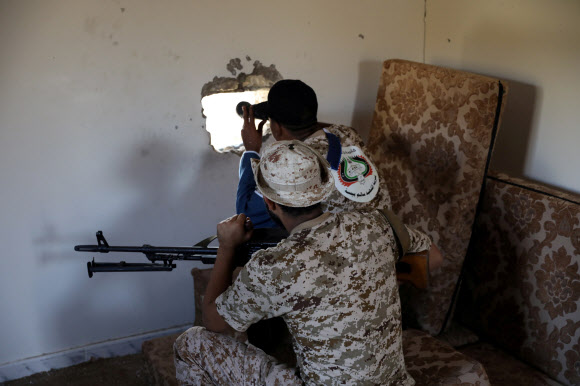 지난해 10월 14일 리바아 군 병사들이 수도 트리폴리에 있는 한 초소에서 망원경으로 밖의 동태를 살펴보고 있다. 트리폴리 로이터 연합뉴스