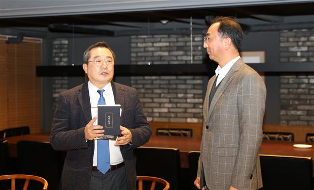 구자열(왼쪽) LS그룹 회장이 신규 임원이 된 LS전선 박현호 이사(LSCI법인장)에게 책을 선물하고 있다. LS그룹 제공