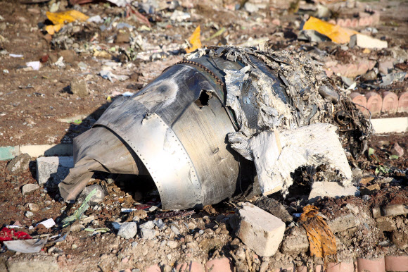 Debris of a plane belonging to Ukraine International Airlines, that crashed after taking off from Iran‘s Imam Khomeini airport, is seen on the outskirts of Tehran