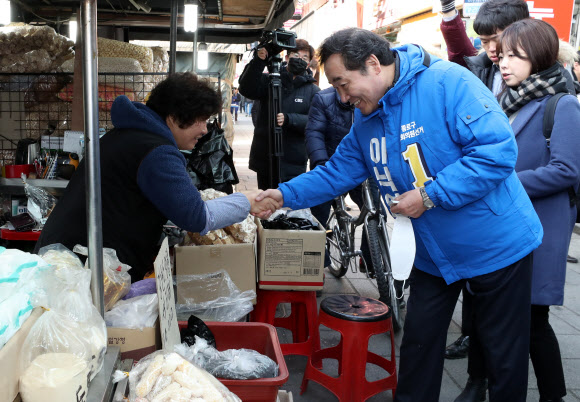4·15총선에서 더불어민주당 후보로 서울 종로에 출마한 이낙연 전 국무총리가 10일 종로구 창신동 거리에서 상인과 악수를 하고 있다.  연합뉴스