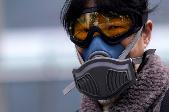 중국 상하이의 한 여성이 13일 방역 마스크를 쓰고 전철역을 이용하고 있다. 2020.2.14  로이터 연합뉴스